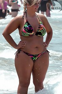 elder dame playing with her large udders on a bed