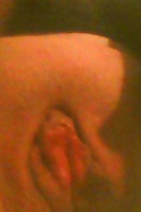 a girl in stocking is toying with her fuckbox on the bed